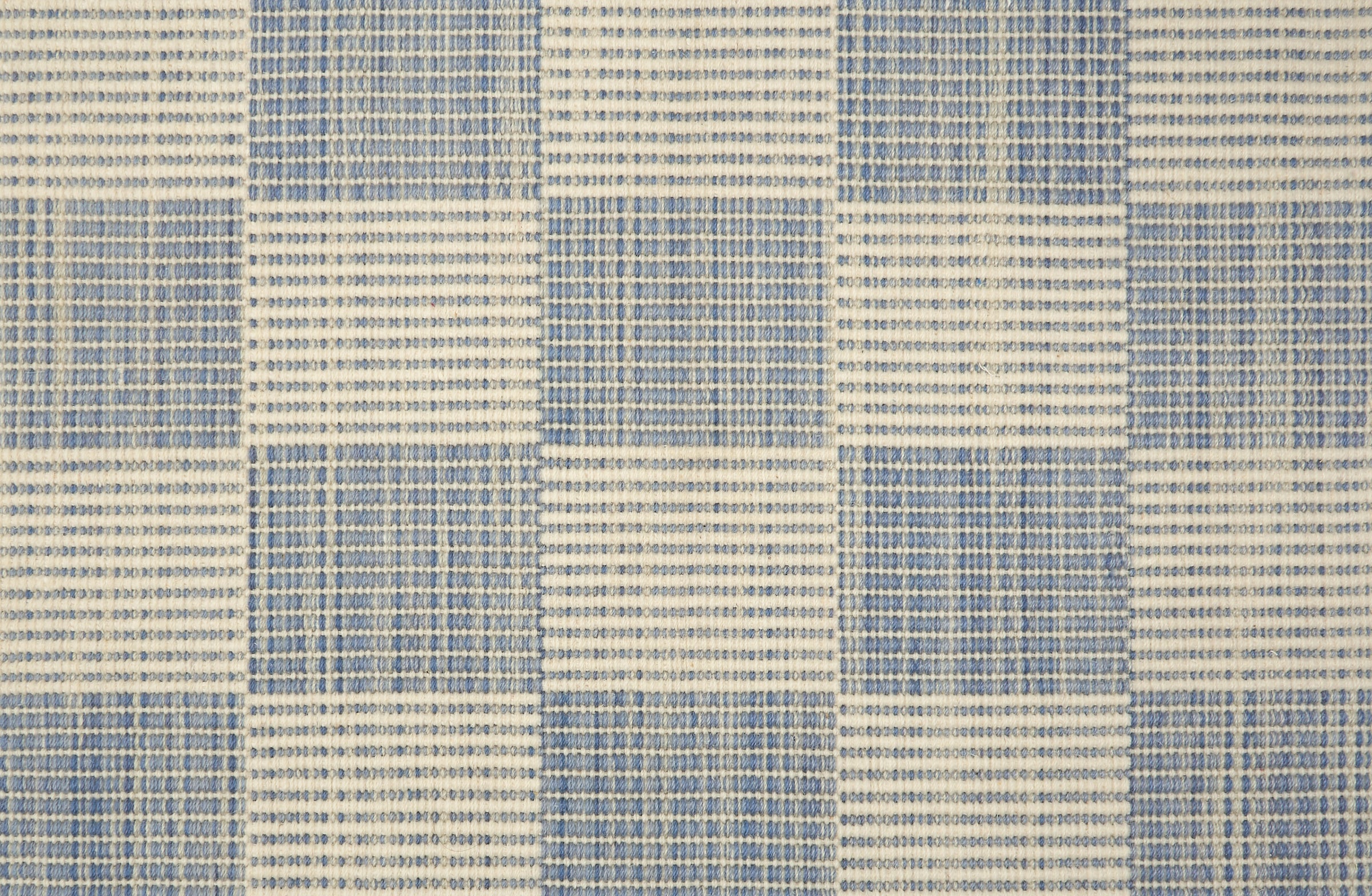Textured blue and beige checkered rug pattern