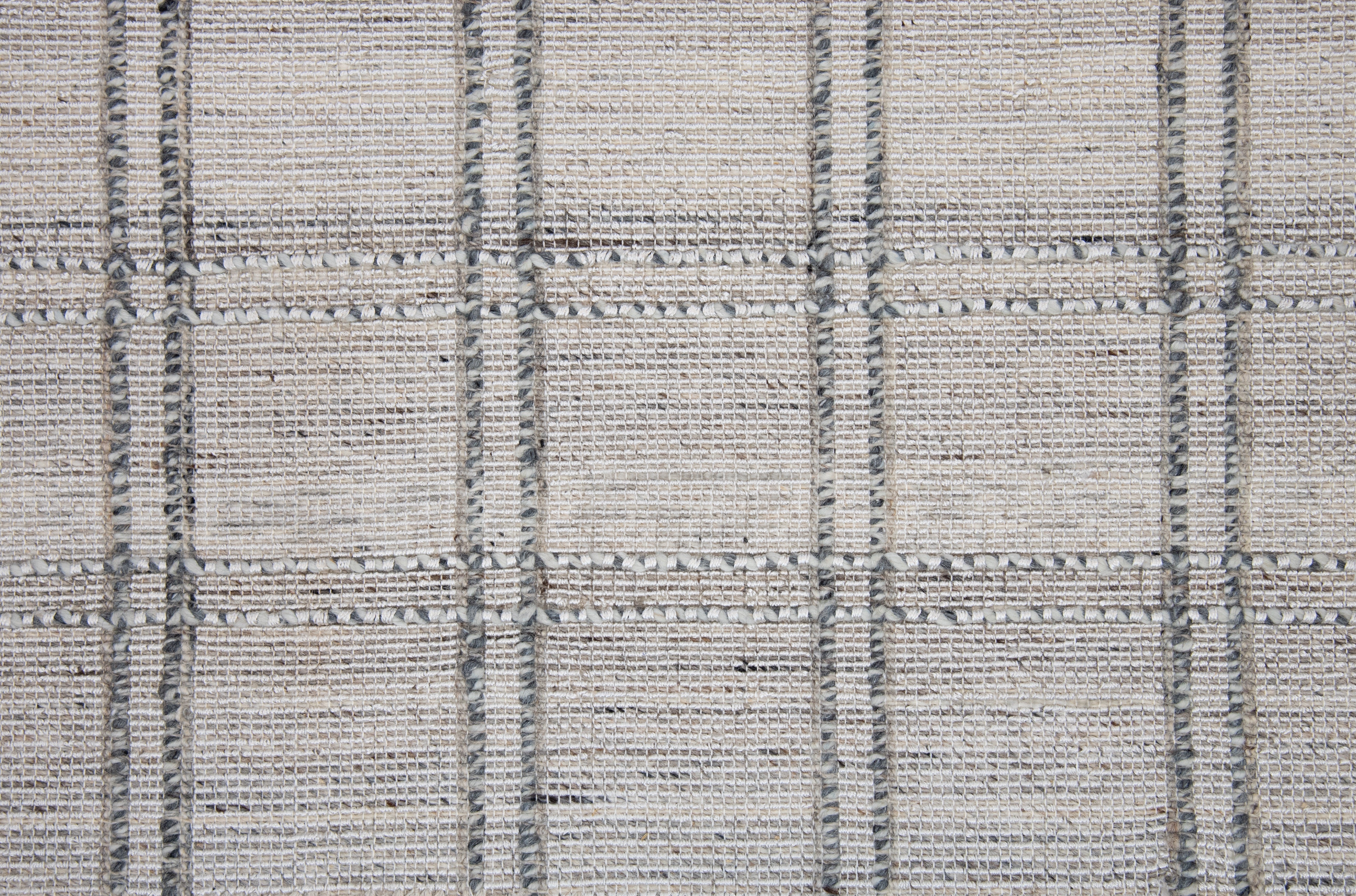 Close-up of gray and white tweed rug with checkered pattern