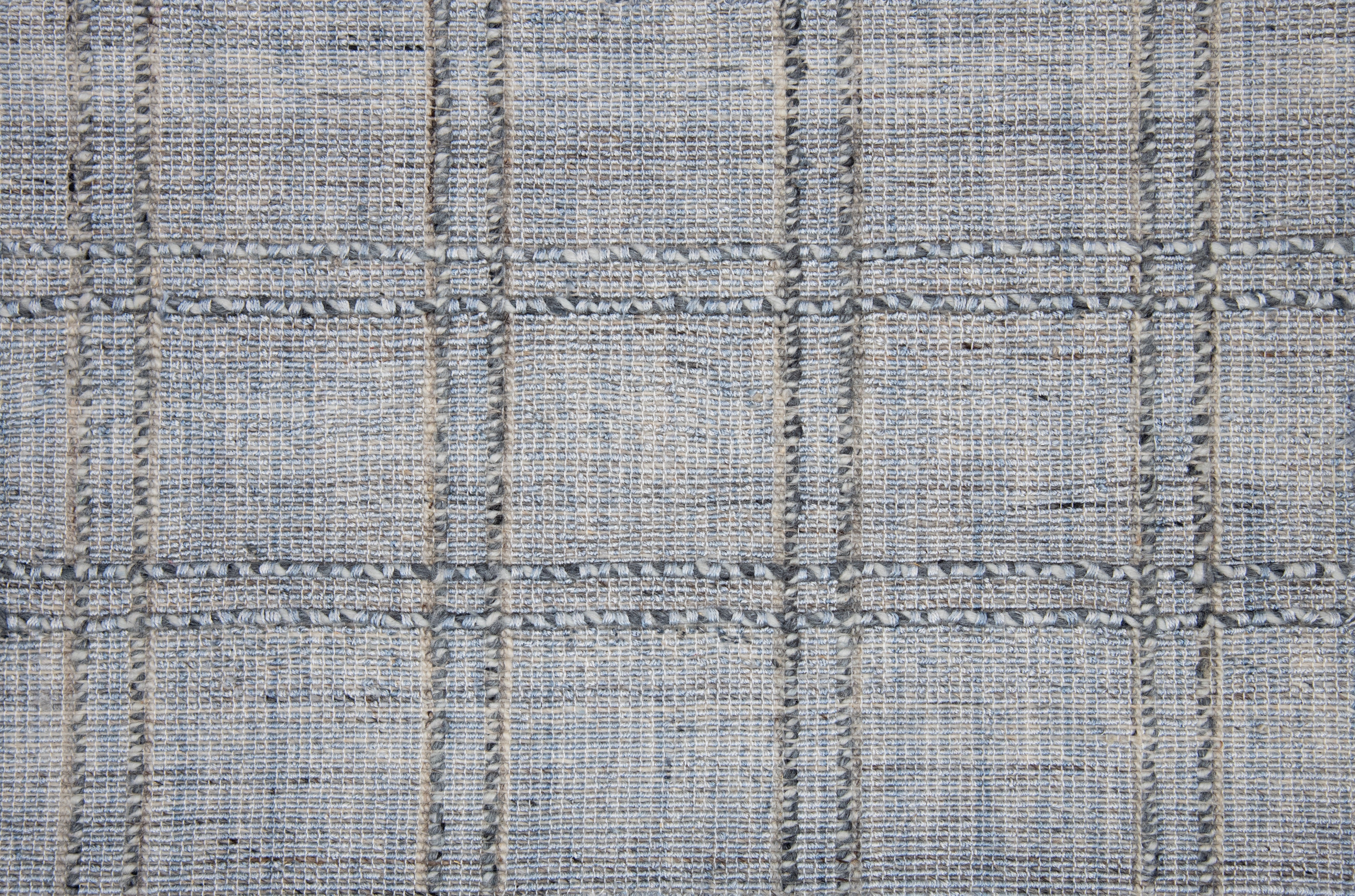 Textured gray tweed rug with grid pattern