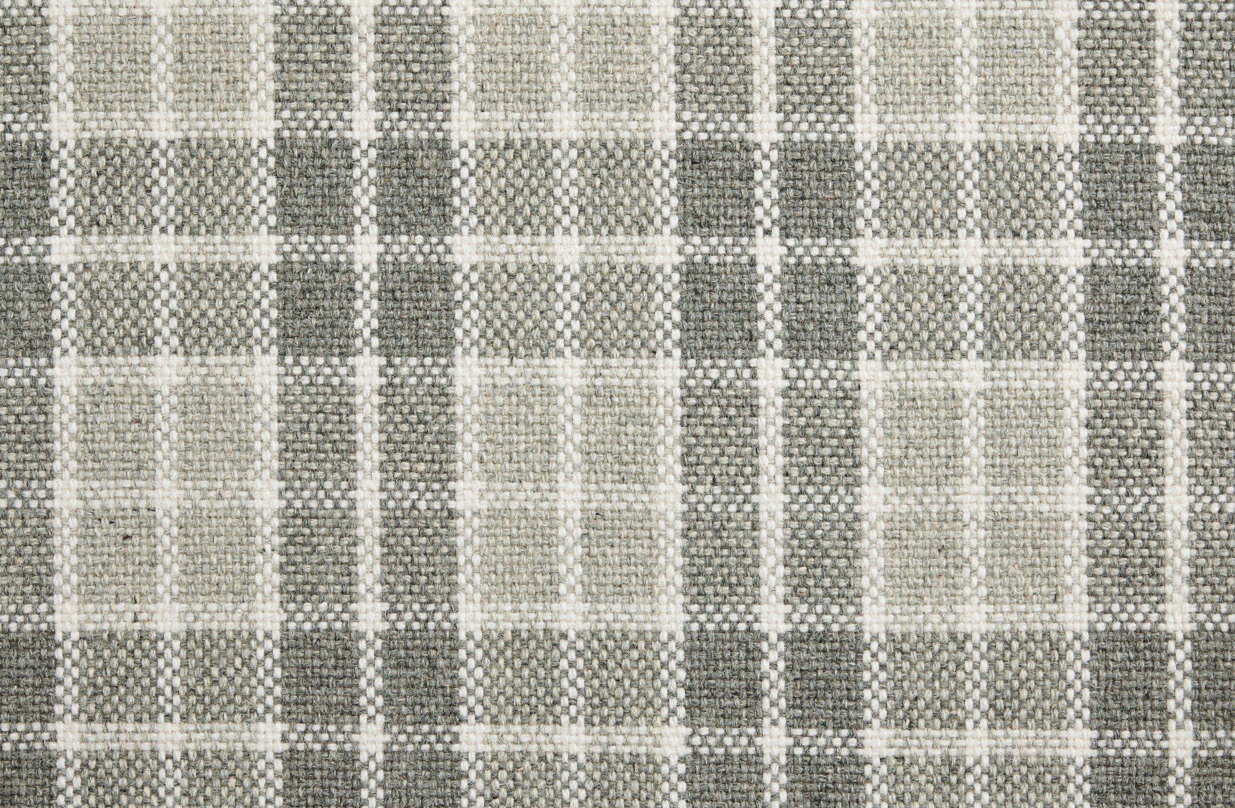 Gray and beige checkered fabric rug with textured weave pattern